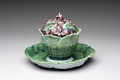 A polychrome Dutch Delft 'mulberries' tureen and cover on stand, 18th C.