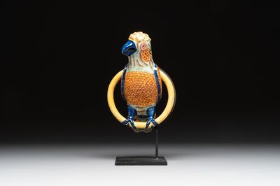 A polychrome Dutch Delft parrot on a later metal stand, 18/19th C.