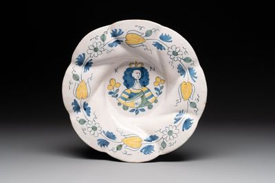 A polychrome Dutch Delft twisted 'Queen Mary' dish, erroneously inscribed K N, 17th C.