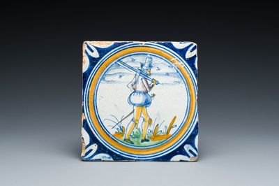 A polychrome Dutch maiolica medallion tile with a soldier, late 16th C.