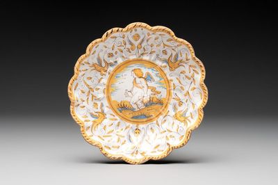 A polychrome Dutch maiolica 'putto and dog' plate, Verstraeten workshop, Haarlem, 17th C.