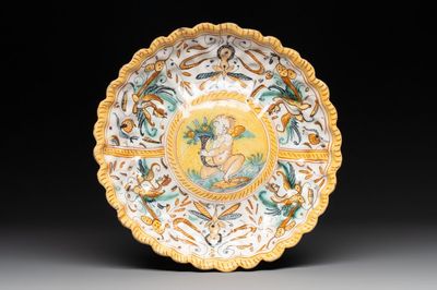 A polychrome Italian maiolica plate with a putto, Deruta, 17th C.