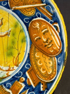 A polychrome Italian maiolica plate with a putto surrounded by trophies, Pesaro, 16th C. — photo 5