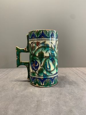 A polychrome Iznik-style mug with tulips and carnations, Kutahya, Turkey, 19th C. — photo 1