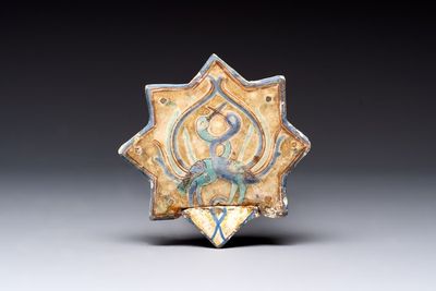 A polychrome Kashan relief-moulded star-shaped tile with herons, Persia, 14th C.