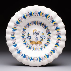 A polychrome lobed Dutch Delftware dish with a putto smoking a pipe, probably Verstraeten workshop, Haarlem, 17th C. — photo 1