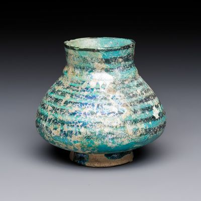 A Raqqa turquoise and black pottery jar with horizontal stripes, Syria, 13th C.
