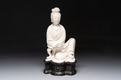 A rare and elegant Chinese Dehua blanc de Chine Guanyin on a wooden stand, Transitional period
