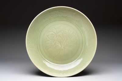 A rare and large Chinese Longquan celadon 'lotus bouquet' dish, Ming, early 15th C.