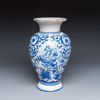 A rare blue and white Brussels faience vase with a cherub trumpeter, Stevens workshop, 19th C.