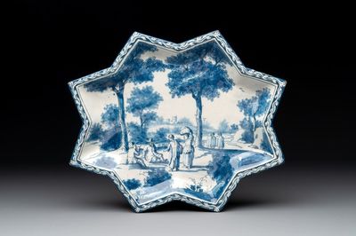 A rare blue and white Dutch Delft star-shaped dish with travellers in a landscape, early 18th C.