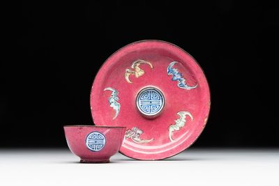 A rare Canton enamel ruby-ground 'Bats and Shou' cup on stand, Qianlong mark and of the period