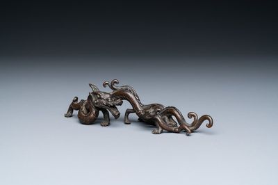 A rare Chinese bronze 'dragon' brush rest, Yuan/Ming