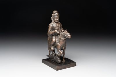 A rare Chinese bronze Vaishravana on horseback with wooden stand, Yuan
