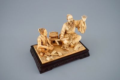 A rare Chinese carved ivory group of a carpenter with student, ca. 1900