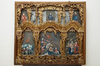 A rare Chinese gilt wood and reverse glass painted mirror, 2nd half 18th C.