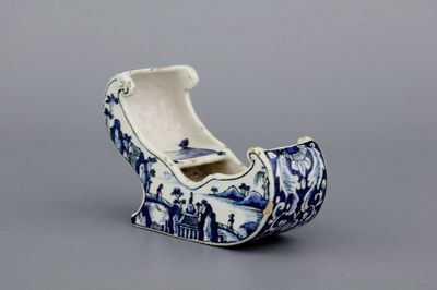 A rare Dutch Delft blue and white pipe holder, modelled as a sleigh, 18th C.