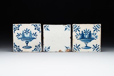 A rare 'empty' blue and white Dutch Delft tile and two 'fruit bowl' tiles, 17th C.