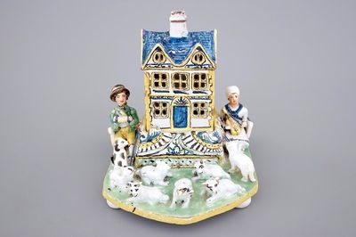 A rare French pottery group with musicians herding sheep by a house, 18th C.