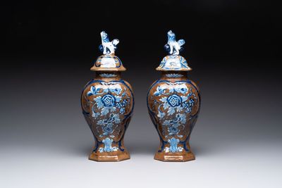 A rare pair of blue and white Dutch Delft brown-ground vases and covers, 18th C.