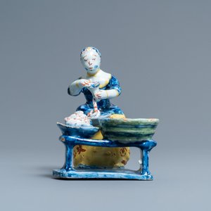 A rare polychrome Dutch Delft figure of a butcher's lady stuffing sausages, 18th C. — 照片 3