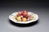 A rare polychrome Dutch Delft trompe-l'oeil dish with apples and walnuts, 17th C.