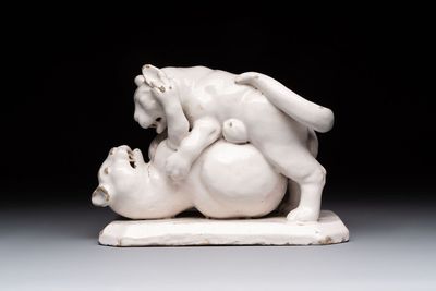 A rare white-glazed Delftware group of two fighting felines, early 18th C.