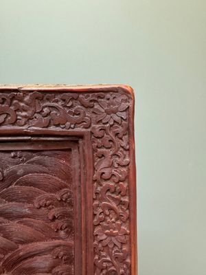 A rectangular Chinese carved red lacquer 'dragon' table screen, later wooden stand, Qianlong — photo 11