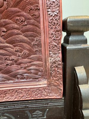 A rectangular Chinese carved red lacquer 'dragon' table screen, later wooden stand, Qianlong — photo 12