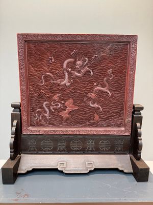A rectangular Chinese carved red lacquer 'dragon' table screen, later wooden stand, Qianlong — photo 2