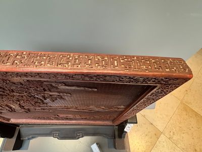 A rectangular Chinese carved red lacquer 'dragon' table screen, later wooden stand, Qianlong — photo 35