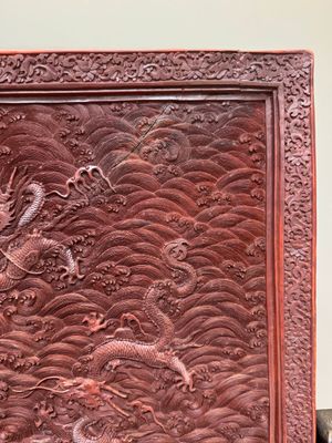 A rectangular Chinese carved red lacquer 'dragon' table screen, later wooden stand, Qianlong — photo 9