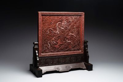 A rectangular Chinese carved red lacquer 'dragon' table screen, later wooden stand, Qianlong