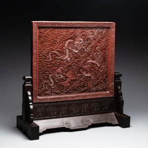 A rectangular Chinese carved red lacquer 'dragon' table screen, later wooden stand, Qianlong — photo 1