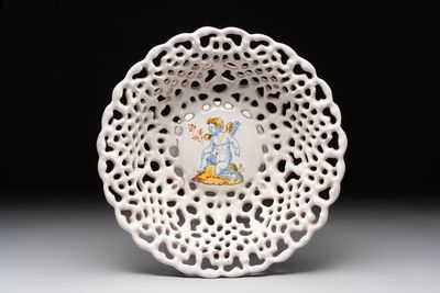 A reticulated Italian blue, white and yellow 'putto' tazza, Faenza, 17th C.