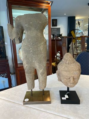 A sandstone torso and a Buddha head, Cambodia, late Khmer period, 13/14th C. — photo 1