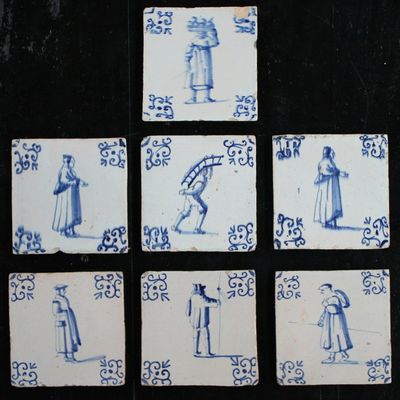 A set of 7 Dutch Delft blue and white tiles with various figures, 17th C.