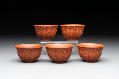 A set of five Chinese Yixing stoneware cups with floral design, Kangxi