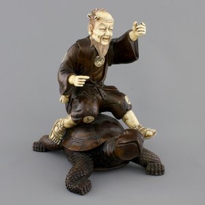 A signed Japanese carved ivory and wood figure of an immortal seated on a turtle, 19th C. — photo 1