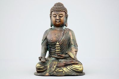 A Sino-Tibetan gilt bronze figure of a seated Buddha, 19th C.