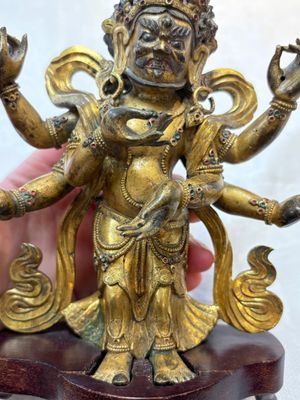 A Sino-Tibetan gilt-bronze figure of White Mahakala on wooden stand, 18th C. — photo 8