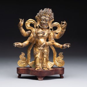 A Sino-Tibetan gilt-bronze figure of White Mahakala on wooden stand, 18th C. — photo 1