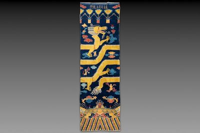 A Sino-Tibetan inscribed woollen 'dragon' pillar carpet, 19th C.