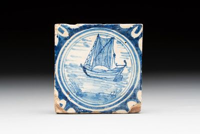 A small blue and white Dutch Delft 'boat' medallion tile, late 16th C.