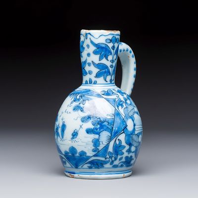 A small blue and white Dutch Delft chinoiserie ewer with figural and floral design, 17th C.