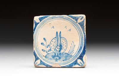 A small blue and white Dutch Delft 'rabbit' medallion tile, late 16th C.