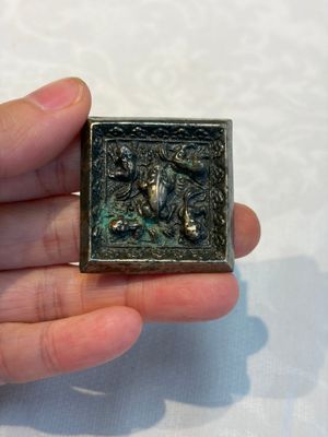 A small Chinese metal-alloy square mirror with relief design, Tang — photo 1