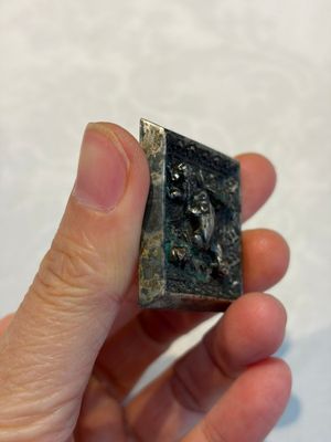 A small Chinese metal-alloy square mirror with relief design, Tang — photo 5