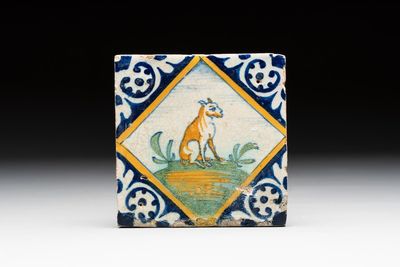 A small polychrome Dutch Delft maiolica 'dog' tile, late 16th C.