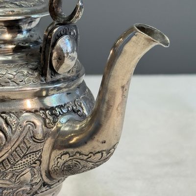 A South-East Asian repoussé silver teapot and a covered box — photo 8